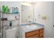 Bathroom with single sink vanity, mirror, and shelving for toiletries and storage at 1363 Briar Meadow Ct, Indianapolis, IN 46217