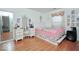 Comfortable bedroom featuring hardwood floors, a vanity with mirror, and a bed at 1363 Briar Meadow Ct, Indianapolis, IN 46217