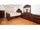 A well-lit primary bedroom featuring hardwood floors and matching furniture at 1363 Briar Meadow Ct, Indianapolis, IN 46217