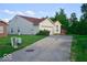 Cozy single-story house featuring a brick and siding combo, attached garage, and mature trees in the backyard at 1363 Briar Meadow Ct, Indianapolis, IN 46217