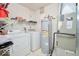 Functional laundry area with washer, dryer, water heater, and storage shelves at 1363 Briar Meadow Ct, Indianapolis, IN 46217