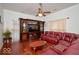 Cozy living room with hardwood floors, a ceiling fan, and a built-in entertainment center at 1363 Briar Meadow Ct, Indianapolis, IN 46217