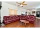 Spacious living room featuring hardwood floors, a ceiling fan, and a large leather sofa at 1363 Briar Meadow Ct, Indianapolis, IN 46217