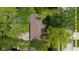 This aerial view reveals the roof of the house and a back patio, all embraced by mature landscaping and trees at 1416 Miami S Ct, Plainfield, IN 46168
