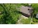 Aerial view from above the tree line offers a glimpse of the home's roof, patio, and brick exterior at 1416 Miami S Ct, Plainfield, IN 46168