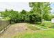 Backyard featuring a garden area with brick borders and a mature tree at 1440 Brandt Dr, Indianapolis, IN 46241