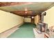 Unfinished basement with a wood burning stove, exposed ceiling beams, and painted cinder block walls at 1440 Brandt Dr, Indianapolis, IN 46241