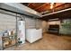 Unfinished basement featuring water heater, freezer and vintage shelving at 1440 Brandt Dr, Indianapolis, IN 46241