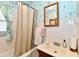 Bathroom featuring blue wallpaper, white tile, a shower-tub and a wood vanity at 1440 Brandt Dr, Indianapolis, IN 46241