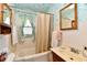 Bathroom featuring blue wallpaper, white tile, a shower-tub and a window at 1440 Brandt Dr, Indianapolis, IN 46241
