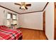 Bright bedroom featuring hardwood floors, wood trim and a ceiling fan at 1440 Brandt Dr, Indianapolis, IN 46241