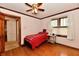 Bedroom featuring hardwood floors, wood trim, a ceiling fan and a twin bed at 1440 Brandt Dr, Indianapolis, IN 46241