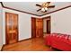 Bright bedroom featuring hardwood floors, wood trim and doors, plus a ceiling fan at 1440 Brandt Dr, Indianapolis, IN 46241