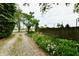 Gravel driveway bordered by a fence with flowers and greenery leading to a house at 1440 Brandt Dr, Indianapolis, IN 46241