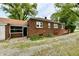 Charming brick home featuring a convenient ramp for easy access and mature trees at 1440 Brandt Dr, Indianapolis, IN 46241