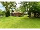 Rear exterior showcasing large lush yard with mature trees at 1440 Brandt Dr, Indianapolis, IN 46241