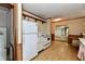 Functional kitchen featuring white appliances and wood shelving with a view into the next room at 1440 Brandt Dr, Indianapolis, IN 46241