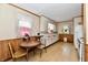 Vintage kitchen with white cabinets, a small dining table, and floral wallpaper at 1440 Brandt Dr, Indianapolis, IN 46241