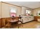 Retro kitchen featuring wood paneling, vintage white cabinetry, and laminate flooring at 1440 Brandt Dr, Indianapolis, IN 46241