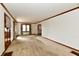Spacious living room with carpet, wood trim, and natural light from windows at 1440 Brandt Dr, Indianapolis, IN 46241