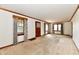 Large living room with carpet, wood trim, and an entry door at 1440 Brandt Dr, Indianapolis, IN 46241