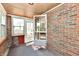 Cozy sunroom with brick walls, offering ample natural light at 1440 Brandt Dr, Indianapolis, IN 46241