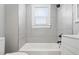 Stylish bathroom features a tub, shower, modern vanity and tiled walls at 1521 N Gladstone Ave, Indianapolis, IN 46201