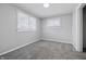 Light-filled bedroom offers neutral paint and carpeting, with bright windows at 1521 N Gladstone Ave, Indianapolis, IN 46201