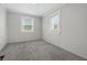 A bedroom features gray walls, bright windows, and gray carpeting at 1521 N Gladstone Ave, Indianapolis, IN 46201