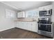 Modern kitchen featuring stainless steel appliances, white cabinetry, and great natural light at 1521 N Gladstone Ave, Indianapolis, IN 46201