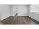 Open living room showing view into kitchen, complete with wood-look floors and neutral color palette at 1521 N Gladstone Ave, Indianapolis, IN 46201