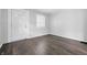 Bright living room with gray walls, wood-look floors and a beautiful door with intricate glass detail at 1521 N Gladstone Ave, Indianapolis, IN 46201
