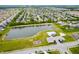 Aerial view of community showing pond, pool, playground, and residential streets at 15580 Garrano Ln, Fishers, IN 46040
