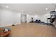 Finished basement with laminate flooring, recessed lighting, and gym equipment at 15580 Garrano Ln, Fishers, IN 46040