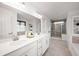 Bright bathroom with a double vanity, quartz countertop, tiled shower, and soaking tub at 15580 Garrano Ln, Fishers, IN 46040