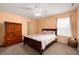 Cozy bedroom with a wooden bed, matching dresser, and a bright window at 15580 Garrano Ln, Fishers, IN 46040