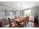 Bright dining room with large window, hardwood floors, and elegant chandelier at 15580 Garrano Ln, Fishers, IN 46040