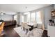 Bright dining area featuring a modern table, chairs, and a view of the backyard at 15580 Garrano Ln, Fishers, IN 46040