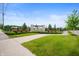 Street view of The Sanctuary at Steeplechase entrance featuring stone pillars, decorative shrubs, and manicured landscaping at 15580 Garrano Ln, Fishers, IN 46040