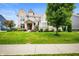 Traditional home with brick and siding, complemented by a green lawn and mature tree at 15580 Garrano Ln, Fishers, IN 46040