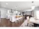 Gourmet kitchen open to the living room with a large island, bar stools, and modern appliances at 15580 Garrano Ln, Fishers, IN 46040