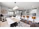 Open-concept kitchen with white cabinets, a large island, and views into the living and dining areas at 15580 Garrano Ln, Fishers, IN 46040