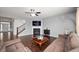 Cozy living room featuring a fireplace, hardwood floors, and a comfortable seating arrangement at 15580 Garrano Ln, Fishers, IN 46040