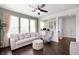 Bright living room featuring a comfortable sofa, chair, and ottoman near a large window at 15580 Garrano Ln, Fishers, IN 46040