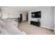Comfortable loft area featuring a plush sofa, TV, and plenty of natural light at 15580 Garrano Ln, Fishers, IN 46040