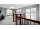 Upstairs loft area with a large window, plush carpet, and ample space for relaxation at 15580 Garrano Ln, Fishers, IN 46040