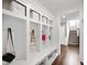 Bright mudroom featuring built-in storage, coat hooks, and bench seating, creating an organized entry space at 15580 Garrano Ln, Fishers, IN 46040