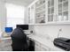 Well-lit home office with modern desk, comfortable chair, built-in storage, and stylish decor at 15580 Garrano Ln, Fishers, IN 46040