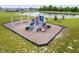 Community playground with swings, slides, and benches near a pond at 15580 Garrano Ln, Fishers, IN 46040