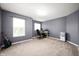 Spacious room with carpet, ample natural light, and a guitar against the wall at 15580 Garrano Ln, Fishers, IN 46040